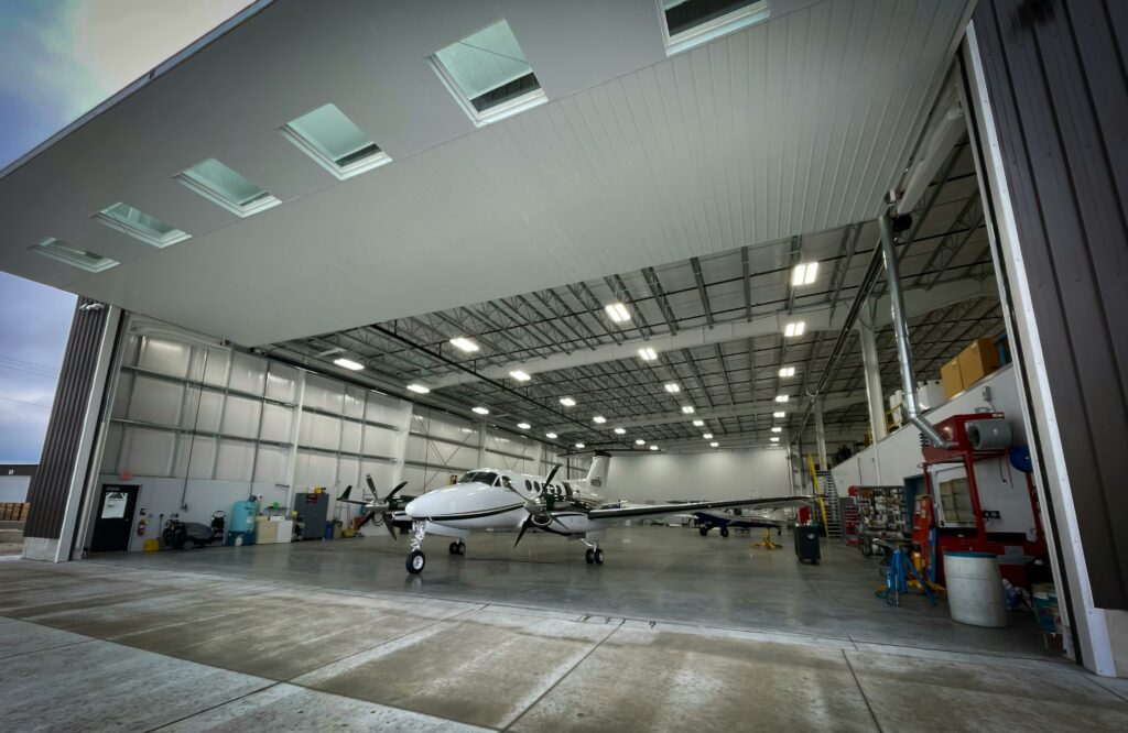 A private propeller aircraft inside a maintenance hangar undergoing a Part CAO airworthiness review